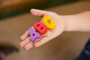 Hand holding alphabet blocks